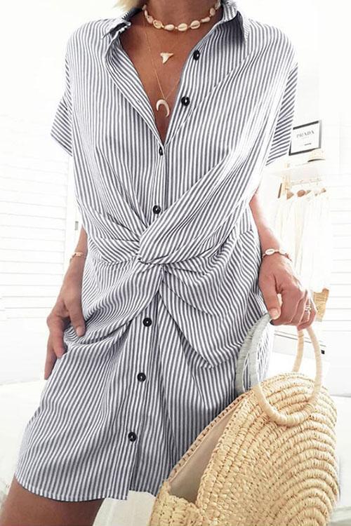 Close-up of a blue and white striped shirt dress with a twist knot detail.