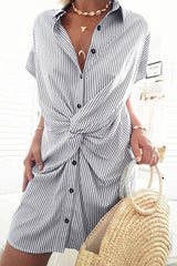 Close-up of a blue and white striped shirt dress with a twist knot detail.