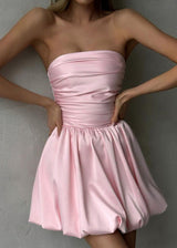 woman in a pink strapless ruched bodice bubble skirt dress with hands on hips