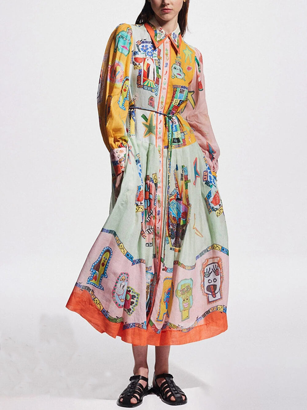 woman wearing a long, flowing, multi-colored dress with an abstract print and a collared neckline