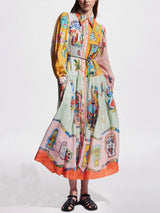 woman wearing a long, flowing, multi-colored dress with an abstract print and a collared neckline