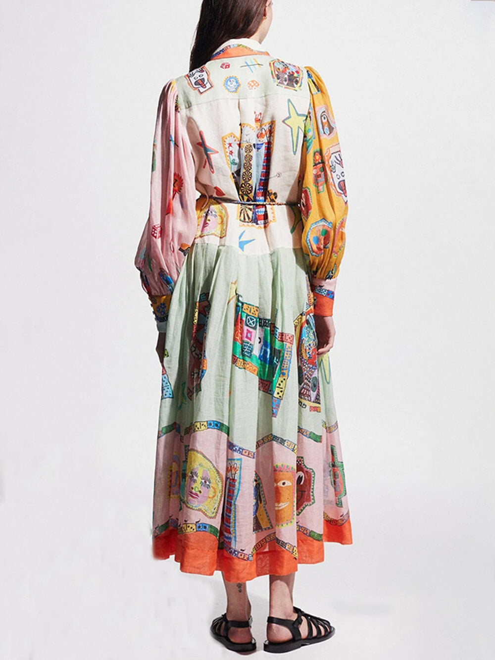 back view of a woman in a multi-colored abstract print dress