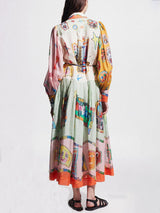 back view of a woman in a multi-colored abstract print dress