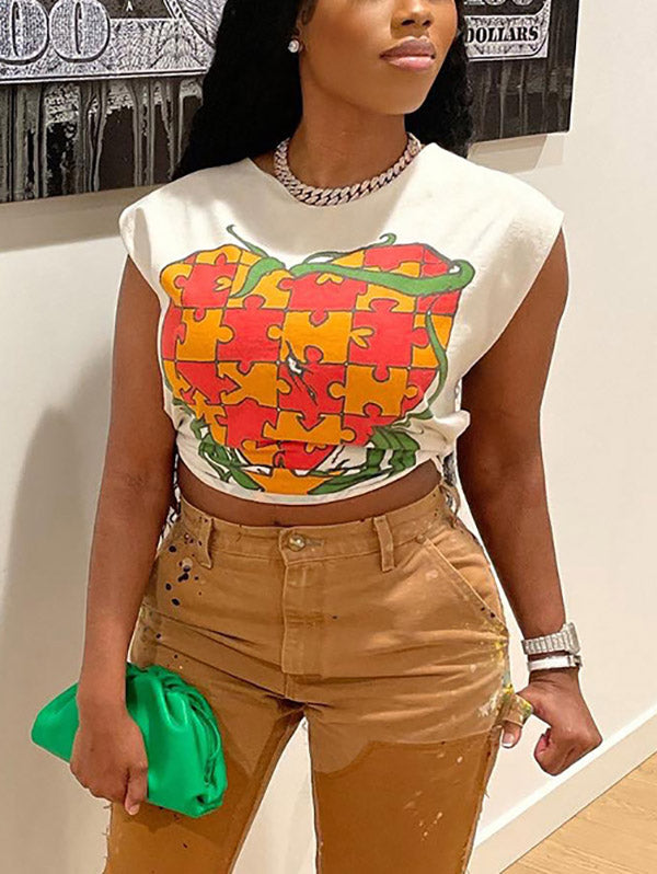 Woman in a white graphic t-shirt and brown distressed pants