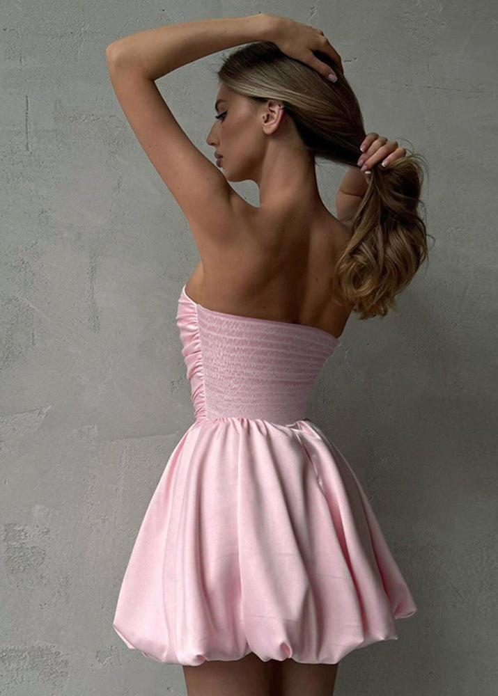 back view of a woman in a pink strapless ruched bodice bubble skirt dress