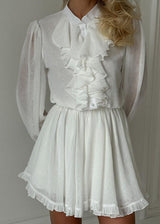 close-up of woman in white dress from the front
