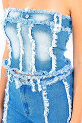 close-up of the front of a blue denim strapless top with frayed detailing