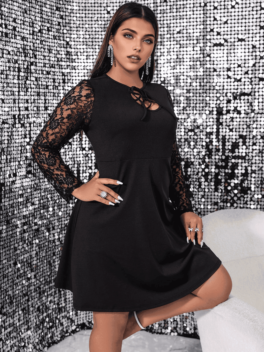 woman in black dress posing with hand on hip