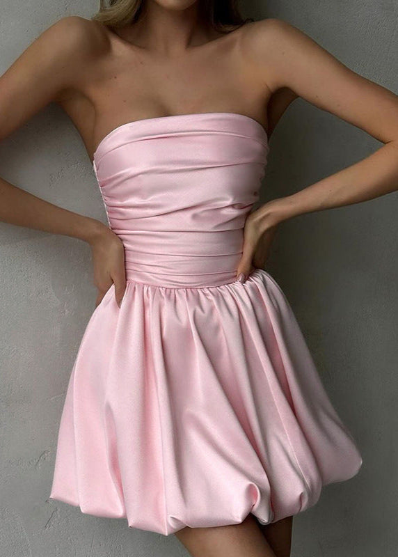close-up of a woman in a pink strapless ruched bodice bubble skirt dress