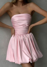 close-up of a woman in a pink strapless ruched bodice bubble skirt dress