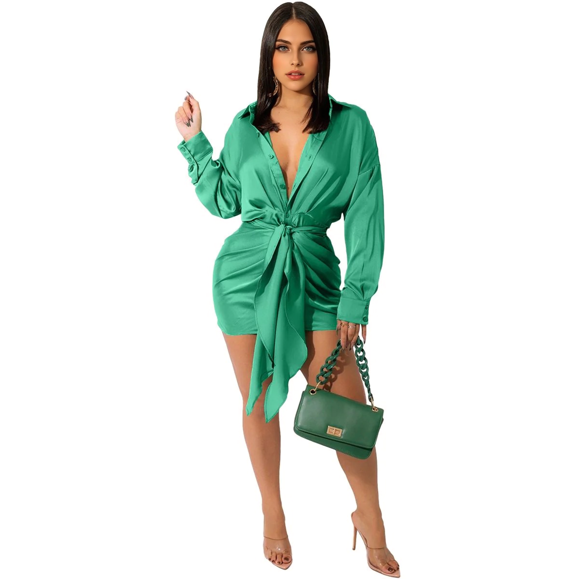 Woman in a green satin mini dress with a plunging V-neck and a tie waist, holding a green handbag.