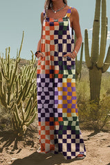 Woman wearing a colorful checkered jumpsuit, standing in a desert landscape with cacti.