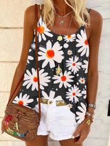 Woman wearing a black tank top with a white daisy print, white shorts, and a woven crossbody bag.