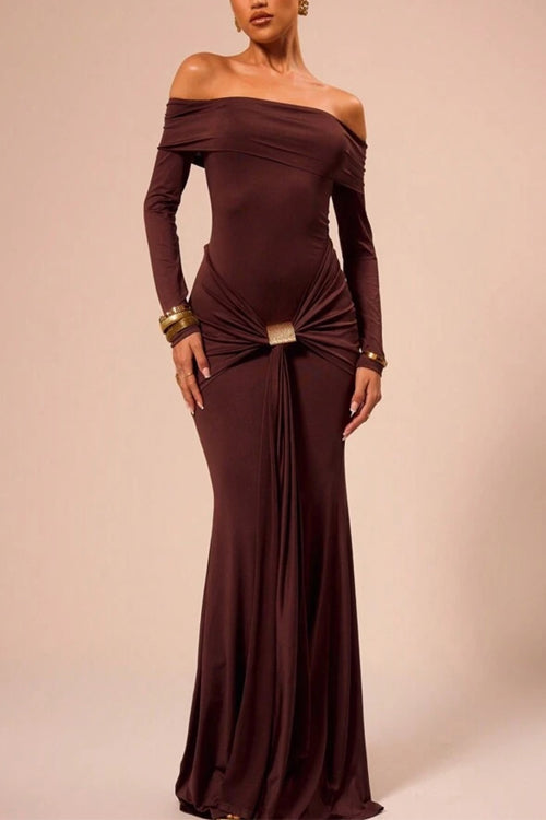 Woman wearing a long, off-the-shoulder brown dress with ruched detailing and a gold buckle at the waist.