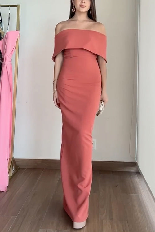Full-length view of a woman in a coral mermaid dress.