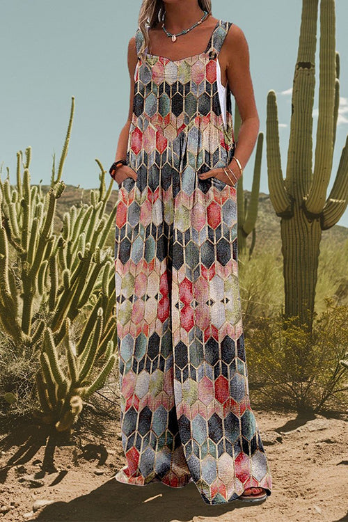 Woman wearing a jumpsuit with a colorful geometric honeycomb pattern, standing in a desert landscape with cacti.