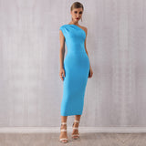 Full body shot of a woman in a blue one-shoulder midi dress, posing with her hand on her hip.