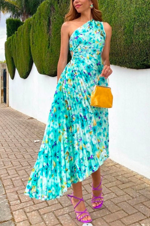 woman in blue and purple floral print one-shoulder pleated dress with cut-out detail and yellow handbag