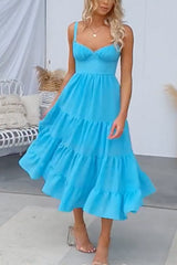 Woman in a blue tiered midi dress from the front