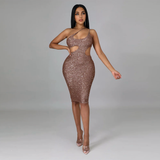 Woman in a bronze sequined one-shoulder dress with cut-outs