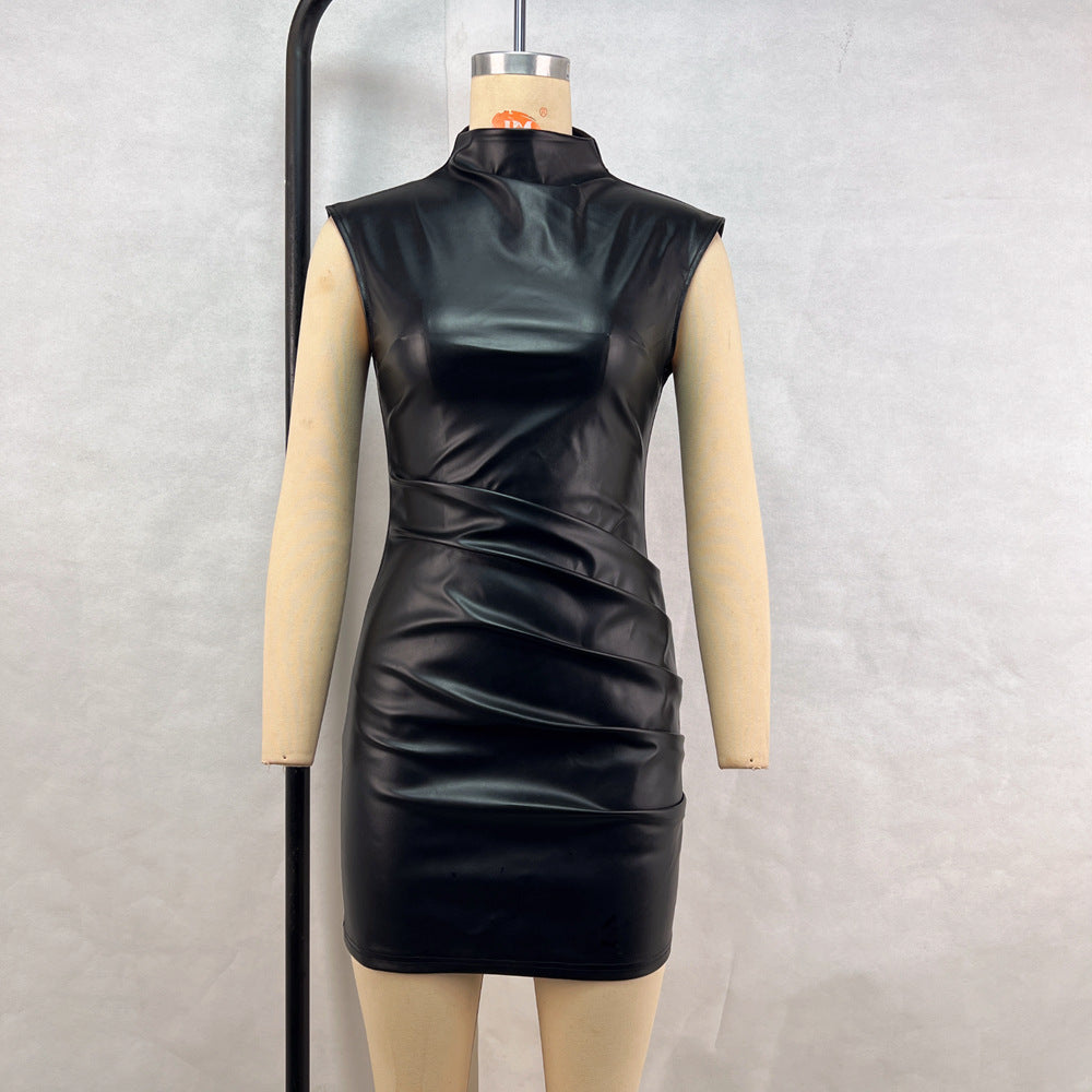 Black leather bodycon dress with ruched detailing and attached gloves displayed on a mannequin.