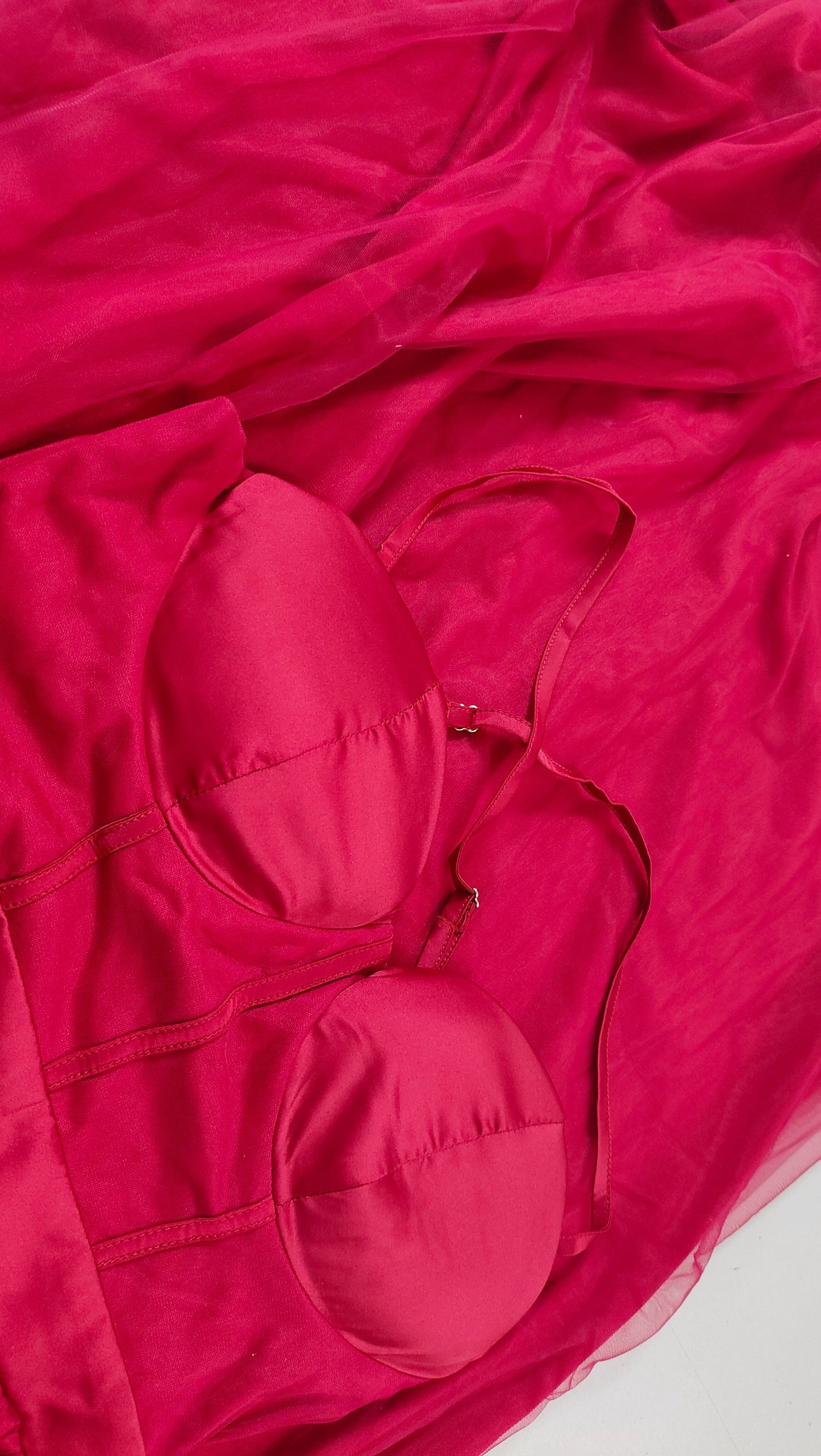 Close-up of a red dress bodice and sheer fabric