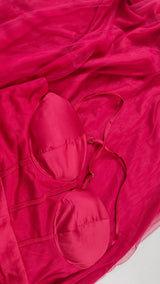 Close-up of a red dress bodice and sheer fabric