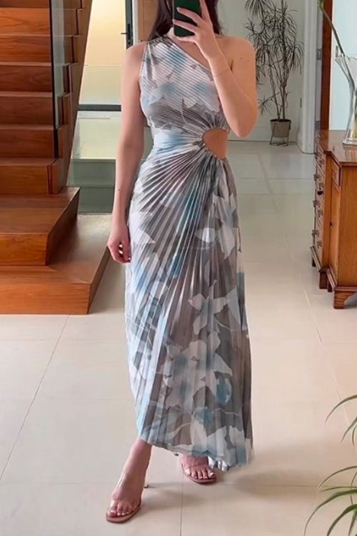 woman in grey and blue floral print one-shoulder pleated dress with cut-out detail