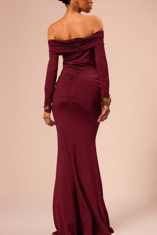 Back view of a woman in a long, off-the-shoulder maroon dress with ruched detailing.