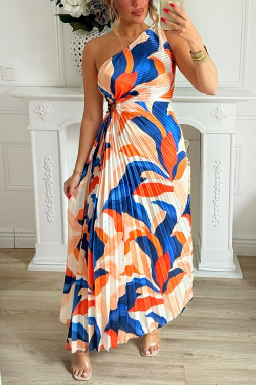 woman in a blue and orange one-shoulder pleated maxi dress with an abstract print