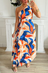 woman in a blue and orange one-shoulder pleated maxi dress with an abstract print