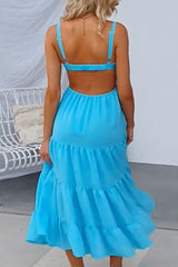 Woman in a blue tiered midi dress from the back