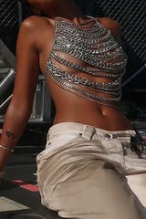Close-up of a woman's torso wearing a silver chain halter top