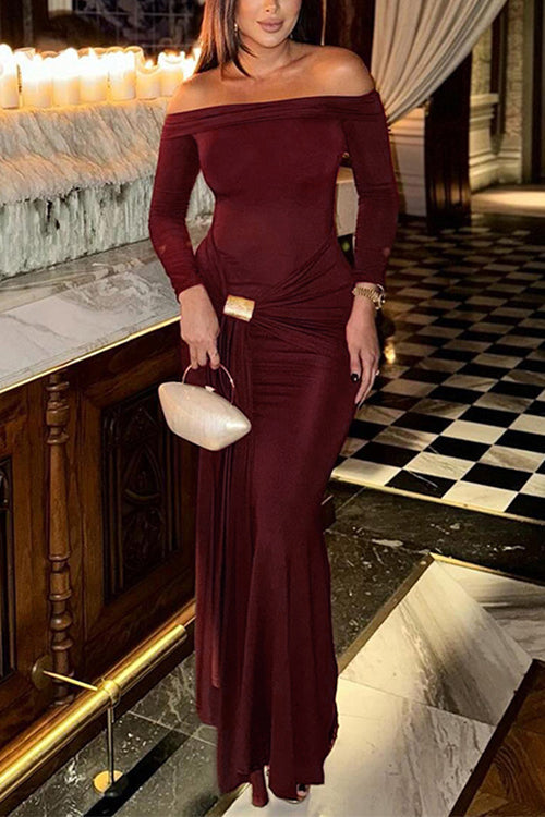 Woman in a maroon off-the-shoulder dress holding a clutch bag in a luxurious setting.