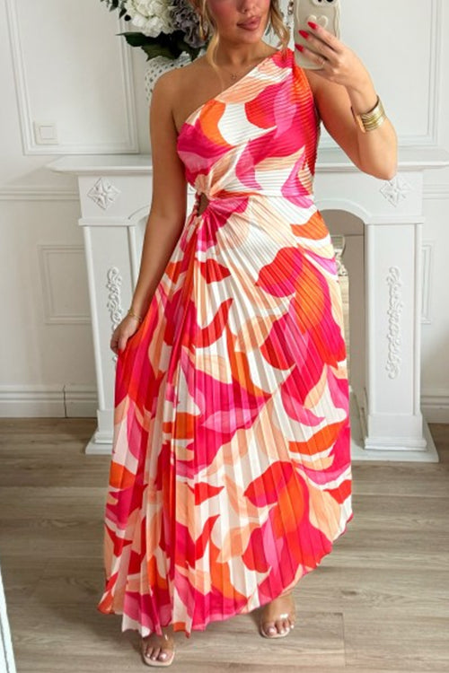 woman in a pink and orange one-shoulder pleated maxi dress with an abstract print