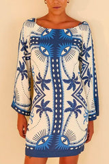 Close-up of a woman's torso wearing a white and blue printed mini dress