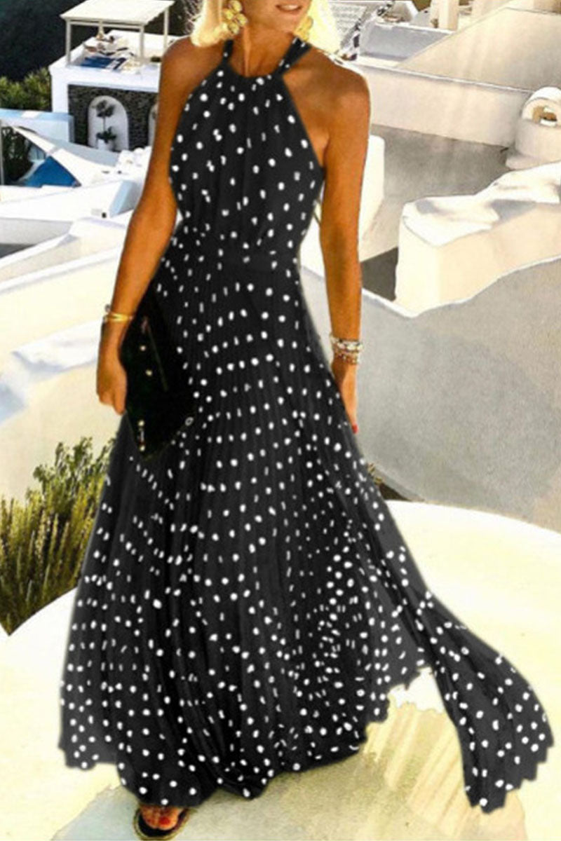 woman in a black polka dot maxi dress