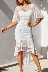 woman in a white lace dress with bell sleeves and a ruffled high-low hem, front view