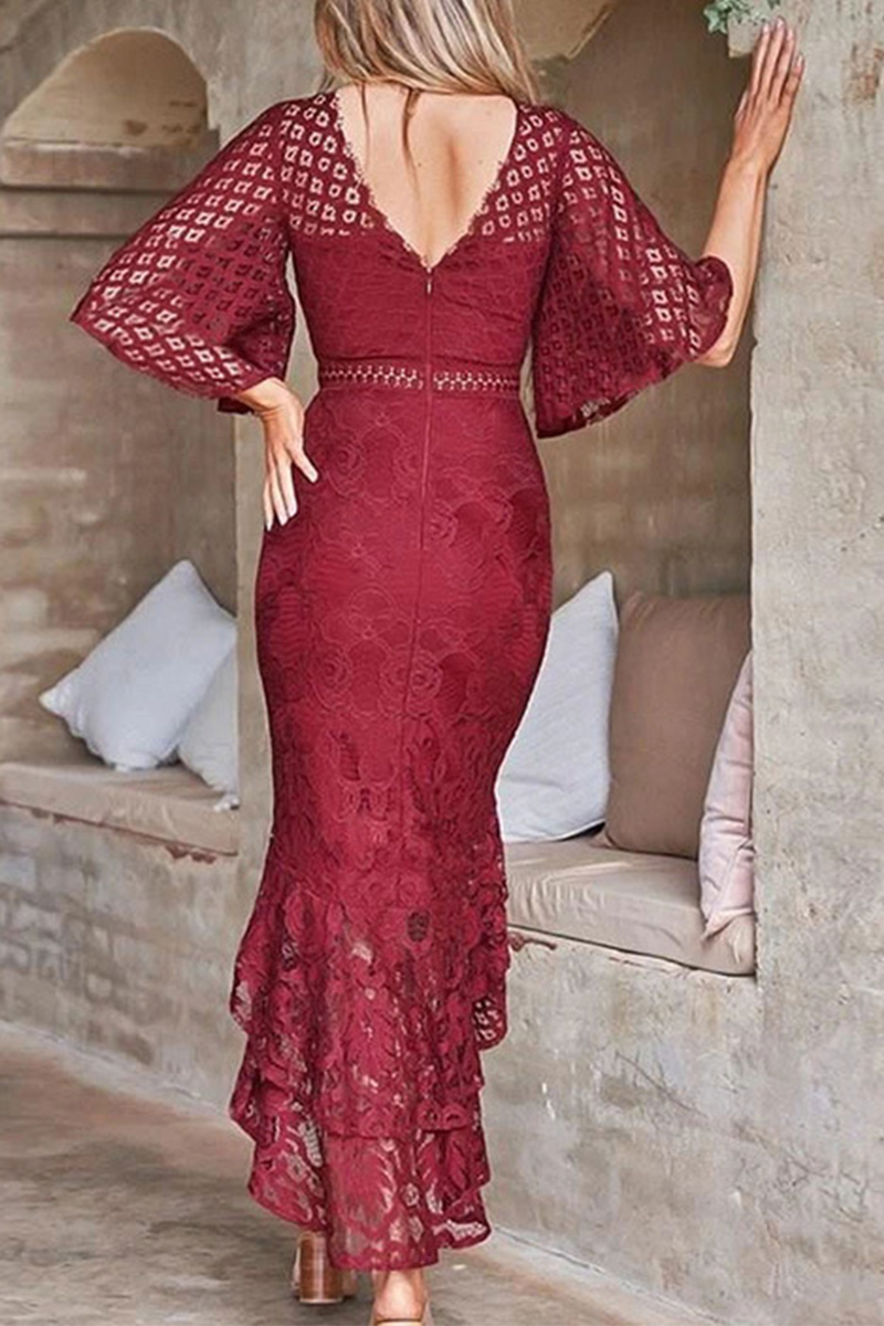 woman in a burgundy lace dress with bell sleeves and a ruffled high-low hem, back view
