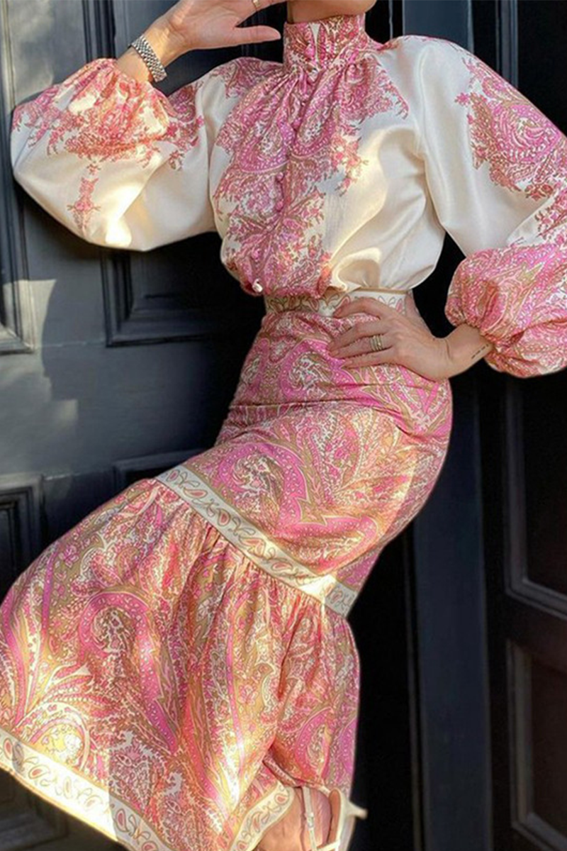 Close-up of a woman's torso in a pink and white paisley print set, showing the details of the blouse and skirt.