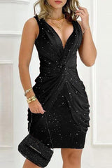 A woman wearing a black sparkly ruched v-neck sleeveless dress, front view