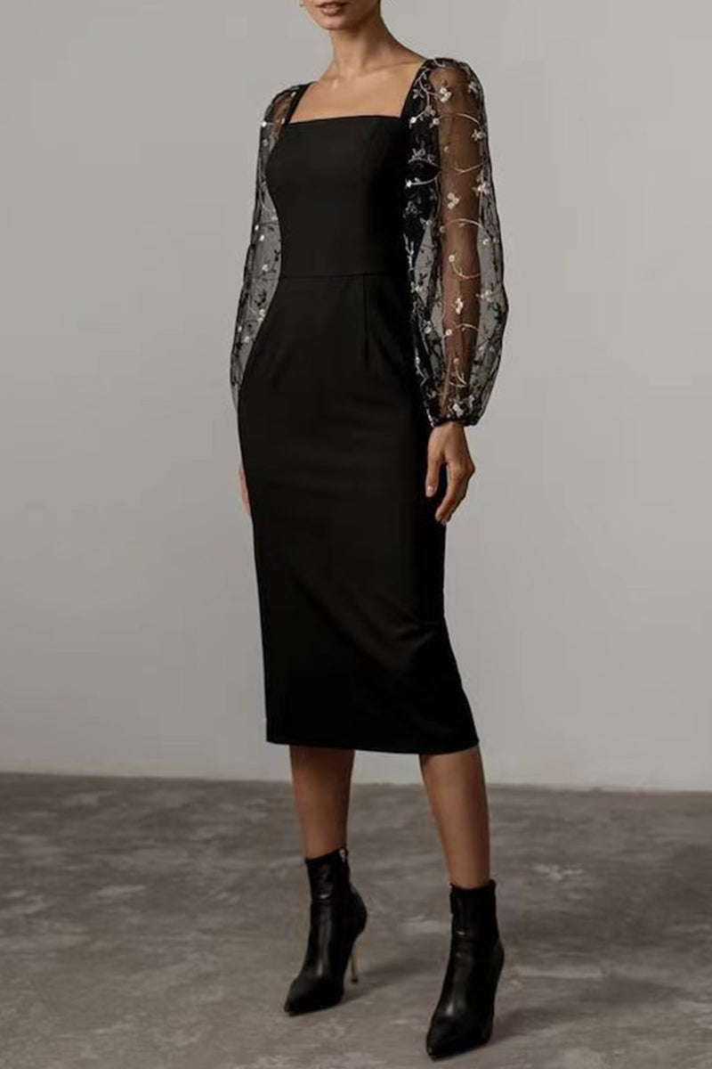 A woman in a black sheath dress with sheer, embellished long sleeves and a square neckline, paired with black ankle boots.
