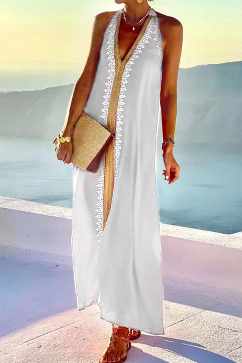 Woman in a white maxi dress with a scenic background