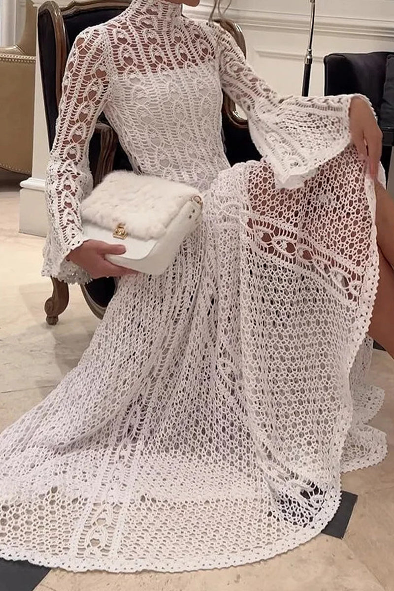 Woman sitting in a white crochet dress holding a white furry clutch