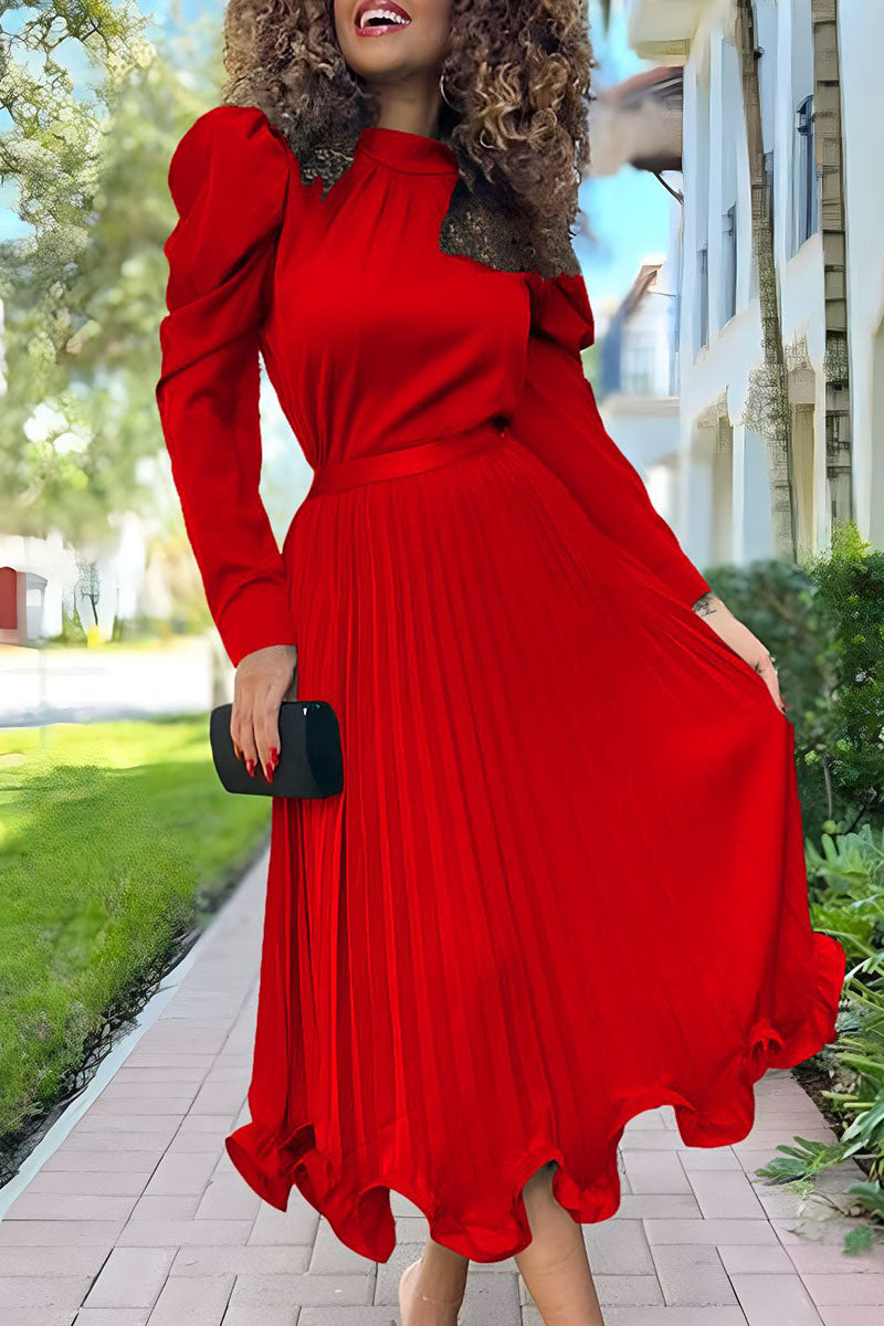 woman in a red pleated dress with puffy sleeves