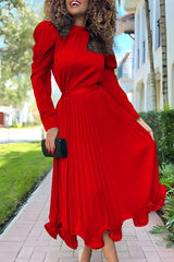 woman in a red pleated dress with puffy sleeves