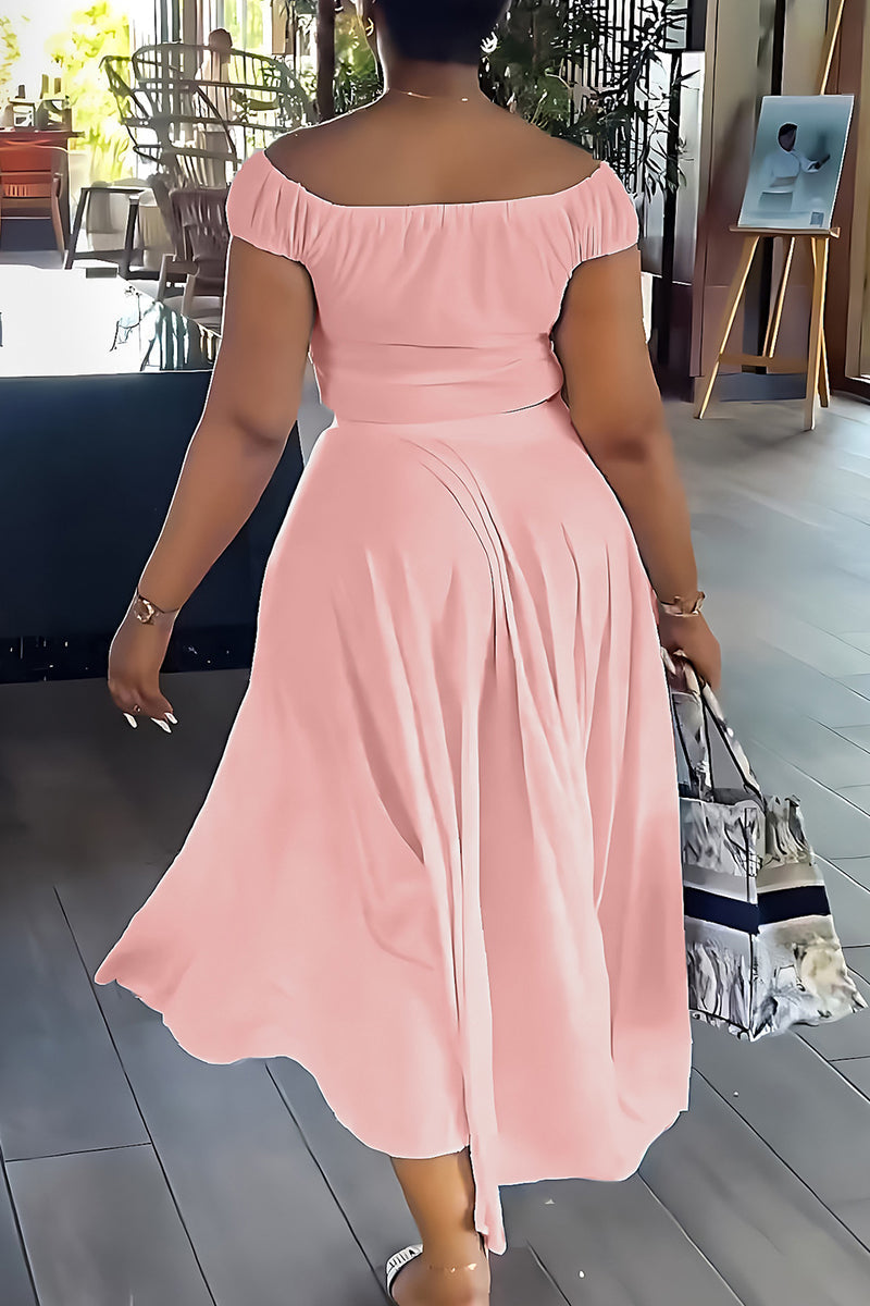 Back view of a woman in a pink off-the-shoulder ruched top and wide-leg pants.