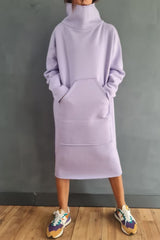 Woman wearing a light purple hooded dress with pockets and colorful sneakers.