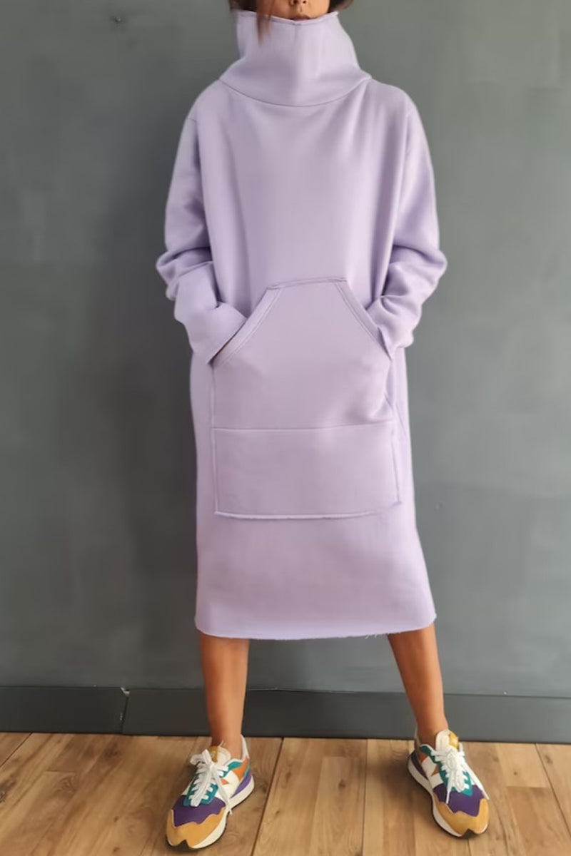 Woman wearing a light purple hooded dress with pockets and colorful sneakers.