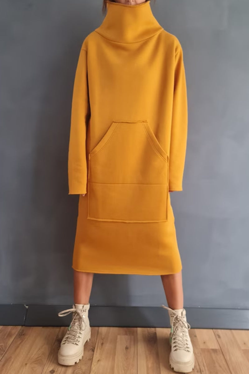 Woman wearing a yellow hooded dress with pockets and white boots.